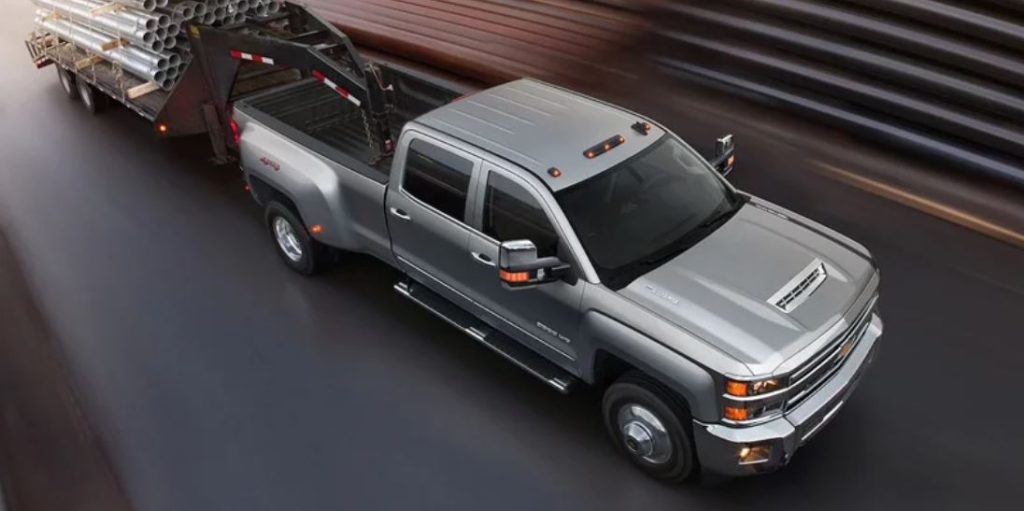 A gray 2022 Chevrolet Silverado 3500 towing and driving through a tunnel.