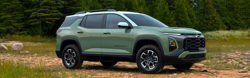 A Chevrolet Equinox SUV parked on a rocky trail, surrounded by trees and nature.