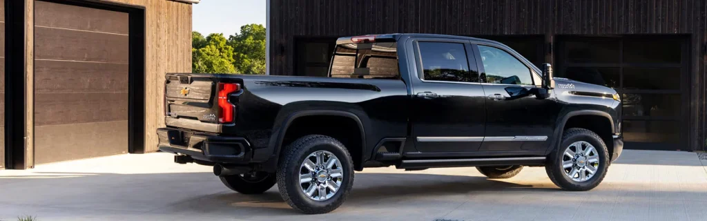 Chevrolet Silverado pickup truck parked in a modern residential driveway beside a garage.