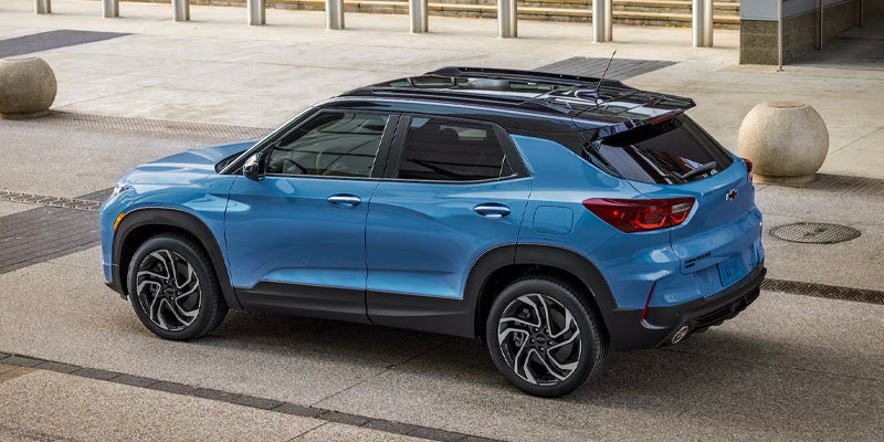 Blue Chevrolet Equinox parked outside a modern building.