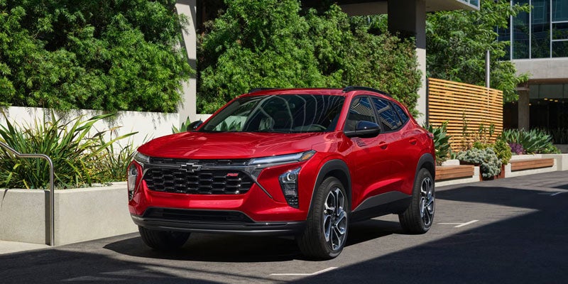 Red Chevrolet SUV parked in a modern outdoor urban setting